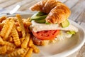 plate of avocado turkey croissant sandwich Royalty Free Stock Photo