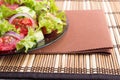 Closeup view of a plate with fresh salad of raw tomatoes Royalty Free Stock Photo