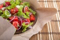 Closeup view on a plate with fresh salad of raw tomatoes, lettuce and onion Royalty Free Stock Photo