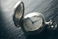 Closeup view of a pocketwatch on a slate - soft focus technique,