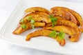 Roasted pumpkin slices with parsley sprigs