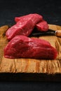 Closeup view of raw beef steak chopped on slices on cutting board Royalty Free Stock Photo