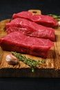 Closeup view of raw beef steak on cutting board Royalty Free Stock Photo