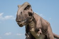 Closeup view of a realistic-looking dinosaur in the park on a sunny day