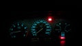 Closeup view of red and blue car speedometers and indicators in the dark of night Royalty Free Stock Photo