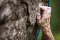 Rock climber`s hand gripping hold on cliff Royalty Free Stock Photo