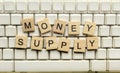 Closeup view row of wooden cubes with Money Supply letters