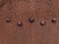 Rusty surface with rivets, part of the remains of the wreck of fishing trawler Epine, at DjÃÂºpalÃÂ³nssandur beach. Royalty Free Stock Photo