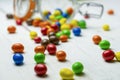 Closeup view of scattered colorful chocolate candies on white wooden background.Multicolored confectionery and sweets background Royalty Free Stock Photo