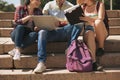 Group of three students sitting on stairs Royalty Free Stock Photo