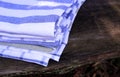 Closeup view on a set kitchen towels on wooden background in nature.Blurred background.