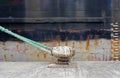 Closeup view of a ship tied to a bollard.