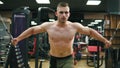 Closeup view of a shirtless handsome athletic man doing pectorals on the crossover trainer in the gym. Shot in 4k