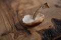 Closeup view of single shiitake mushroom upside down on grainy wooden background Royalty Free Stock Photo