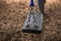 Closeup view from a single swing at a playground. Royalty Free Stock Photo