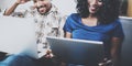 Closeup view of smiling African American couple relaxing together on the sofa.Young black man and his girlfriend using Royalty Free Stock Photo