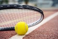 Closeup view on tennis ball and racket racquet lying on acrylic tennis hard court surface with empty blank copy space Royalty Free Stock Photo