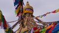 Closeup view of the top Boudhanath stupa in the center of Kathmandu, Nepal with prayer flags flying in the wind. Royalty Free Stock Photo