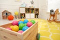 Closeup view of toy car trailer with colorful balls in child`s room, space for text. Interior design Royalty Free Stock Photo