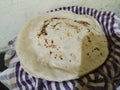 Closeup view of traditional homemade bread called jawar roti or bhakri on a blue striped towel