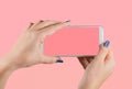 Two female hands holding white modern smartphone Royalty Free Stock Photo