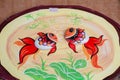 Closeup view of a two fishes. painting on the stone. picture handmade