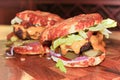 Closeup view of two messy keto burgers on a wooden board