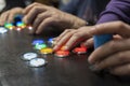 Closeup view of two people hands playing arcade vintage video games.Gamepad with joystick and many colorful buttons .Playful Royalty Free Stock Photo