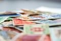 Closeup view on a variety of multi-colored postage stamps from different countries and years. Selective focus