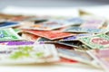 Closeup view on a variety of multi-colored postage stamps from different countries and years. Selective focus