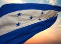 Closeup view of the waving flag of the Honduras on a background of sunset