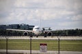 Closeup view of a white plane landing at the airport Royalty Free Stock Photo