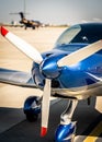 Closeup view of white propeller of the blue sport plane nose Royalty Free Stock Photo