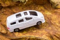 Closeup view of a white toy van with sunroofs  on a brown surface Royalty Free Stock Photo