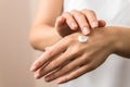 Closeup view of woman hands applying hand cream. beauty shot