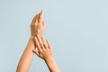 Closeup view of woman hands applying hand cream. beauty shot