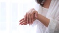 closeup view of woman hands applying hand cream. beauty and wellness products. unrecognizable asian woman takes care of Royalty Free Stock Photo