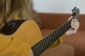 Closeup view woman hands playing western acoustic guitar at home Royalty Free Stock Photo