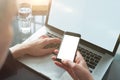 Closeup view woman hands using mobile smartphone and laptop. Space mockup for design layout. Loft interior.