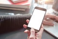 Closeup view woman hands using mobile smartphone and laptop. Space mockup for design layout. Loft interior sunlight.