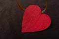 Closeup view of a wooden object designed as a red-colored heart on a black background Royalty Free Stock Photo