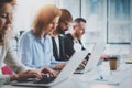 Closeup view of young Coworkers working together on new business presentation at sunny meeting room.Horizontal.Blurred Royalty Free Stock Photo