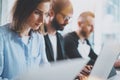 Closeup view of young Coworkers working together on new business presentation at sunny meeting room.Horizontal.Cropped. Royalty Free Stock Photo