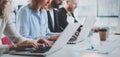 Closeup view of young Coworkers working together on new business presentation at sunny meeting room.Horizontal wide Royalty Free Stock Photo