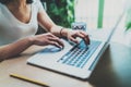 Closeup view of young woman working at home on modern computer.Female hands typing on laptop keyboard while sitting at Royalty Free Stock Photo