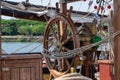 Closeup of a vintage hand wheel on wooden sailing boat. helm of old wooden sailboat Royalty Free Stock Photo