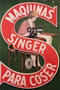 Closeup of vintage, retro poster for Singer sewing machines in Spanish