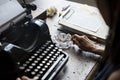 Closeup of vintage retro typewriting with hand and cigarette ashtray Royalty Free Stock Photo