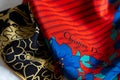 Closeup of vintage silk Christian Dior scarves in red and blue and yellow and black