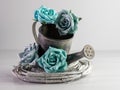 Closeup of a vintage silver-painted watering pot decorated with blue roses Royalty Free Stock Photo